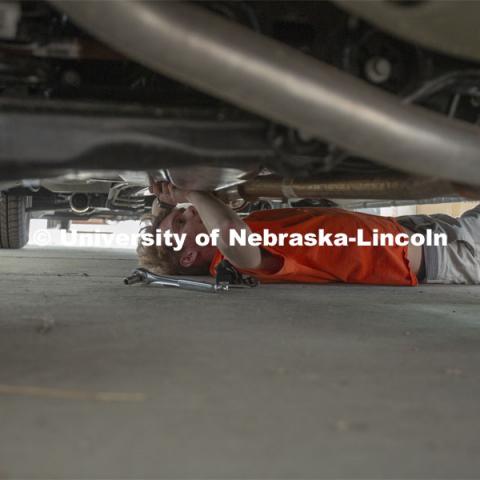 Ben Schweigert, a freshman meteorology major from Omaha, tightens a bolt that holds a tower for a computer display within a mesonet vehicle. Students equipped two of the storm chase vehicles this year, one for the Nebraska team and another for Central Michigan University. The work begins as a class in the fall semester. April 26, 2019. Photo by Troy Fedderson / University Communication