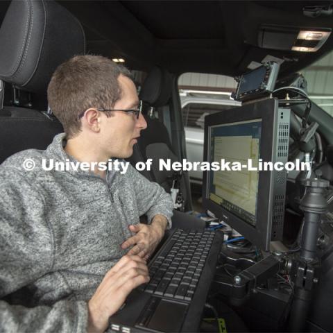 Graduate student Matt Wilson reviews code in programs that are used to collect real-time storm data. All data collected is stored in computers located in the back of Nebraska's mesonet vehicles. The data is backed up daily. April 26, 2019. Photo by Troy Fedderson / University Communication