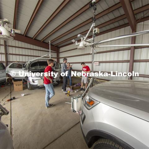 Students meet with Adam Houston (center) as they prep vehicles prior to the start of the TORUS project. TORUS Storm Chasers. April 26, 2019. Photo by Troy Fedderson / University Communication