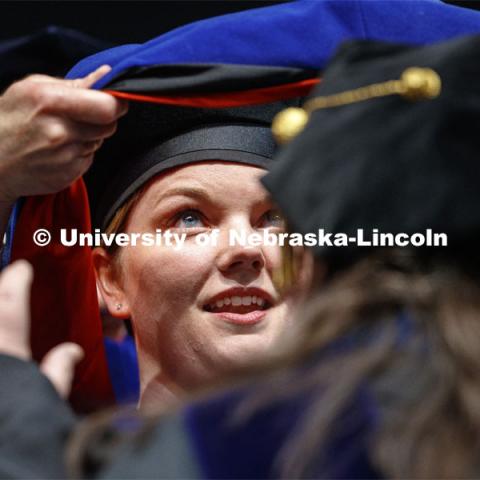 Jaclyn Marsh eyes her doctoral hood. 2019 Spring Graduate Commencement in Pinnacle Bank Arena. May 3, 2019. Photo by Craig Chandler / University Communication