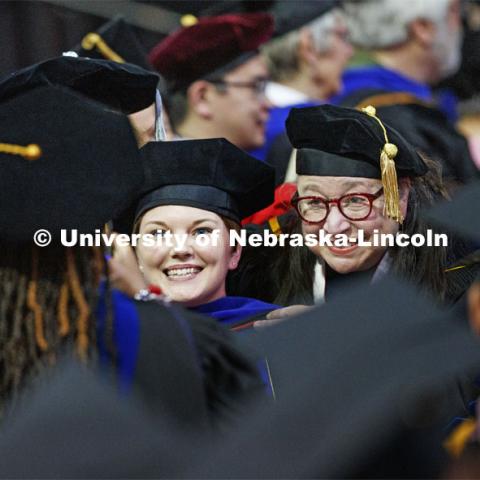 Jaclyn Marsh and her advisor Dawn Braithwaite pose for a photo as they walk along a congratulatory line of faculty in the arena. 2019 Spring Graduate Commencement in Pinnacle Bank Arena. May 3, 2019. Photo by Craig Chandler / University Communication