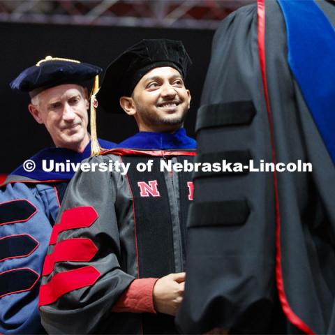 Aditya Gupta receives his doctoral hood. His dissertation: Meaningful Consumption: A Eudaimonic Perspective on the Consumer Pursuit of Happiness and Well-Being. Advised by Professor James W. Gentry. 2019 Spring Graduate Commencement in Pinnacle Bank Arena. May 3, 2019. Photo by Craig Chandler / University Communication