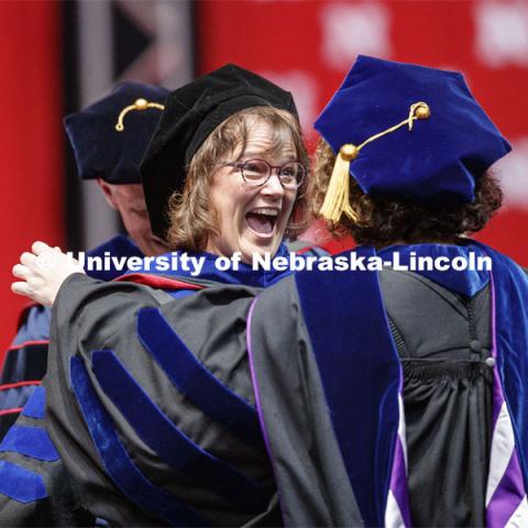 Carin Appleget reacts after her advisor Stephanie Wessels hooded her.  2019 Spring Graduate Commencement in Pinnacle Bank Arena. May 3, 2019. Photo by Craig Chandler / University Communication