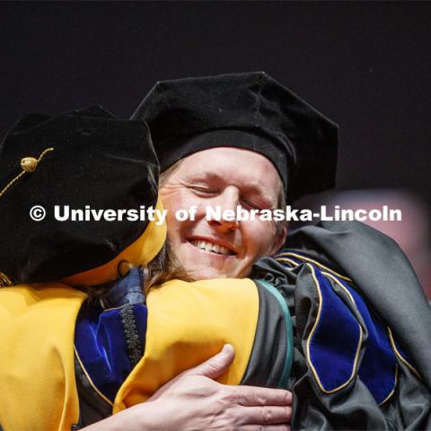 Patrick Janike hugs his advisor Lorraine Males after he received his doctor of education hood. 2019 Spring Graduate Commencement in Pinnacle Bank Arena. May 3, 2019. Photo by Craig Chandler / University Communication