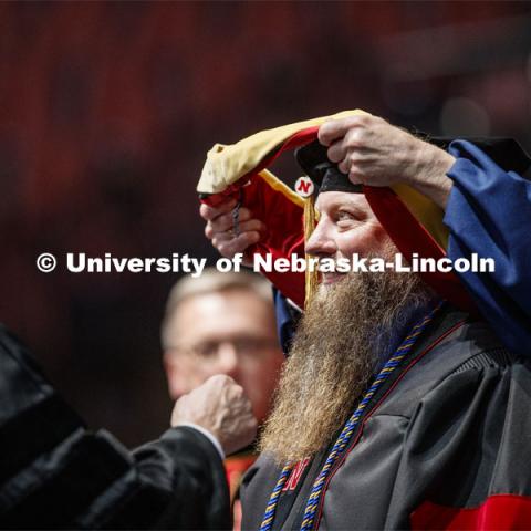 Patrick Janike hugs his advisor Lorraine Males after he received his doctor of education hood. 2019 Spring Graduate Commencement in Pinnacle Bank Arena. May 3, 2019. Photo by Craig Chandler / University Communication