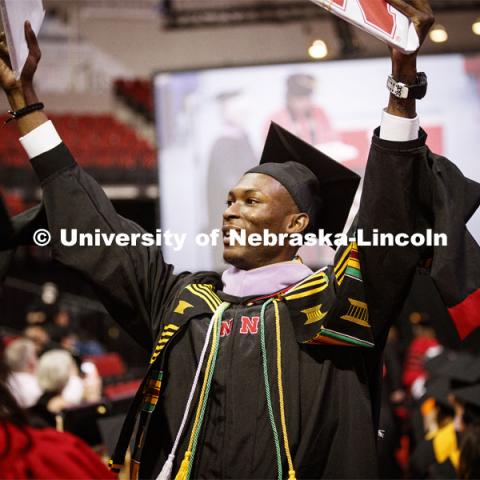 Davielle Phillips shows his family and friends his dual degrees of MBA and Master of Architecture. 2019 Spring Graduate Commencement in Pinnacle Bank Arena. May 3, 2019. Photo by Craig Chandler / University Communication