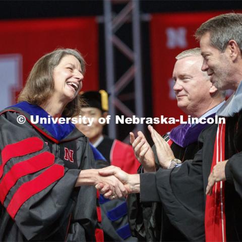 Rebecca Richards-Kortum is congratulated by Regens Time Clare and Jim Pillen after giving the commencement address and accepting the Charles Bessey Medal from Chancellor Ronnie Green. Undergraduate commencement at Pinnacle Bank Arena, May 4, 2019. Photo by Craig Chandler / University Communication.