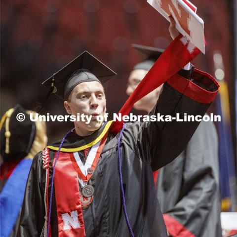Jackson Grasz gestures to family and friends after receiving his College of Business diploma. Undergraduate commencement at Pinnacle Bank Arena, May 4, 2019. Photo by Craig Chandler / University Communication.