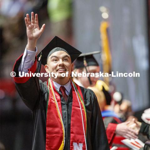 Helmuth Krische gestures to family and friends after receiving his College of Business diploma. Undergraduate commencement at Pinnacle Bank Arena, May 4, 2019. Photo by Craig Chandler / University Communication.