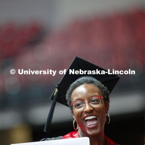 Jewel Rodgers gestures to family and friends after receiving her College of Business diploma. Undergraduate commencement at Pinnacle Bank Arena, May 4, 2019. Photo by Craig Chandler / University Communication.