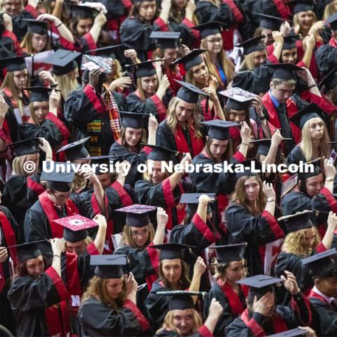 Graduates move their tassels from right to left at the end of the ceremony to signify they are now graduates of the University of Nebraska-Lincoln. Undergraduate commencement at Pinnacle Bank Arena, May 4, 2019. Photo by Craig Chandler / University Communication.