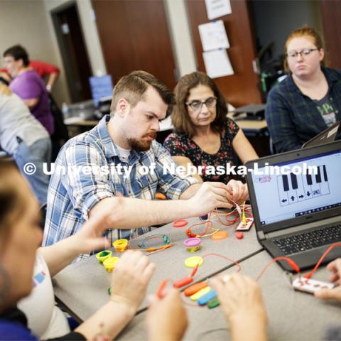 Carl Spicher and Rossella Tesch from the Chadron Public Library work on programming and circuitry that allows small current going through their fingers to play notes on a Play-Doh keyboard, as part of the Library Innovation Studios. Training was held in the Atrium building in downtown Lincoln, Nebraska. May 22, 2019. Photo by Craig Chandler / University Communication.