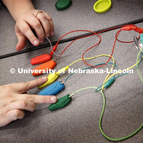 The trainers learn programing and circuitry that allows a small current going through their fingers to play notes on a Play-Doh keyboard, as part of the Library Innovation Studios. Training was held in the Atrium building in downtown Lincoln, Nebraska. May 22, 2019. Photo by Craig Chandler / University Communication.