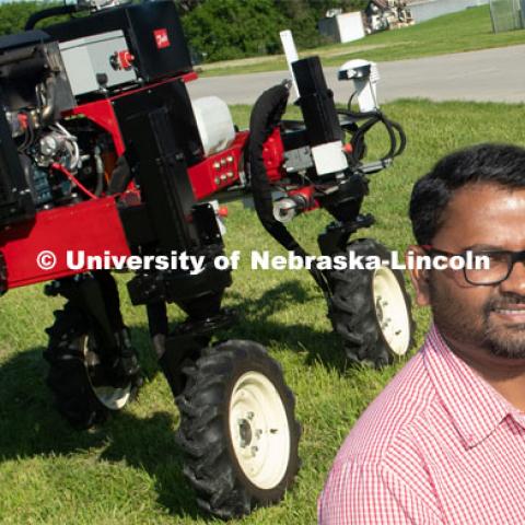 Grad student Josh Murman is with Santosh Pitla, associate professor of advanced machinery systems in the Department of Biological Systems Engineering at the University of Nebraska–Lincoln. Pitla is currently developing an autonomous tractor using ground robotics. Pitla and his team are testing their driverless tractor on the tractor testing field on East Campus. The autonomous tractors are named Flexible Structured Robotic Vehicle (FlexRo), the tractor is currently used for plant phenotyping, which is measuring the physical characteristics of the plant. According to Pitla, cameras are added to the machine to collect images that characterize plant conditions. Photo for the 2019 publication of the Strategic Discussions for Nebraska magazine. June 10, 2019, Photo by Gregory Nathan / University Communication. 