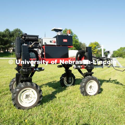 Grad student Josh Murman is with Santosh Pitla, associate professor of advanced machinery systems in the Department of Biological Systems Engineering at the University of Nebraska–Lincoln. Pitla is currently developing an autonomous tractor using ground robotics. Pitla and his team are testing their driverless tractor on the tractor testing field on East Campus. The autonomous tractors are named Flexible Structured Robotic Vehicle (FlexRo), the tractor is currently used for plant phenotyping, which is measuring the physical characteristics of the plant. According to Pitla, cameras are added to the machine to collect images that characterize plant conditions. Photo for the 2019 publication of the Strategic Discussions for Nebraska magazine. June 10, 2019, Photo by Gregory Nathan / University Communication. 