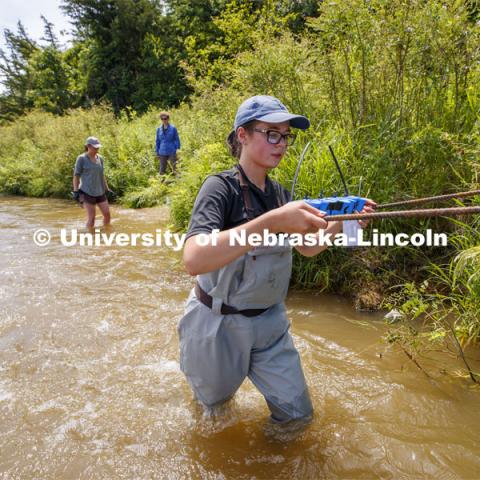 Sydney Kimnach, sophomore in environmental studies and fisheries and wildlife management, carries her research project to the bank of the Niobrara. She places a collection of filter plates each saturated with elements, such as potassium, to see if the algae are attracted to various nutrients. Her multiple sites also allow her to research if algae in different areas of the river seek out different nutrients. Jessica Corman, assistant professor in the School of Natural Resources, UCARE research group researching algae in the Niobrara River. Fort Niobrara National Wildlife Refuge. July 13, 2019. Photo by Craig Chandler / University Communication.