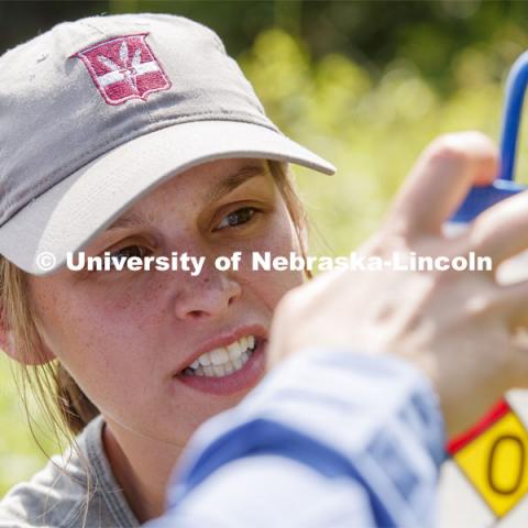 Kayla Vondracek gauges the amount of filtered water left to complete her sampling. Jessica Corman, assistant professor in the School of Natural Resources, UCARE research group researching algae in the Niobrara River. Fort Niobrara National Wildlife Refuge. July 13, 2019. Photo by Craig Chandler / University Communication.