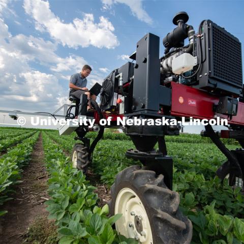 Santosh Pitla, associate professor of advanced machinery systems in the Department of Biological Systems Engineering at the University of Nebraska–Lincoln, is currently developing an autonomous tractor using ground robotics. Pitla and his team are testing their driverless tractor at the Agricultural Research and Development Center (ARDC, MEAD). The autonomous tractors are named Flexible Structured Robotic Vehicle (FlexRo), the tractor is currently used for plant phenotyping, which is measuring the physical characteristics of the plant. According to Pitla, cameras are added to the machine to collect images that characterize plant conditions. Photo for the 2019 publication of the Strategic Discussions for Nebraska magazine. July 17, 2019, Photo by Gregory Nathan / University Communication. 

