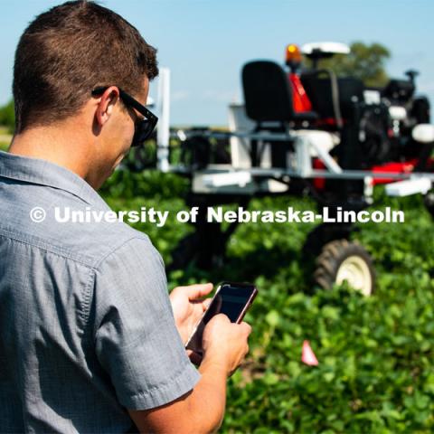 Santosh Pitla, associate professor of advanced machinery systems in the Department of Biological Systems Engineering at the University of Nebraska–Lincoln, is currently developing an autonomous tractor using ground robotics. Pitla and his team are testing their driverless tractor at the Agricultural Research and Development Center (ARDC, MEAD). The autonomous tractors are named Flexible Structured Robotic Vehicle (FlexRo), the tractor is currently used for plant phenotyping, which is measuring the physical characteristics of the plant. According to Pitla, cameras are added to the machine to collect images that characterize plant conditions. Photo for the 2019 publication of the Strategic Discussions for Nebraska magazine. July 17, 2019, Photo by Gregory Nathan / University Communication. 

