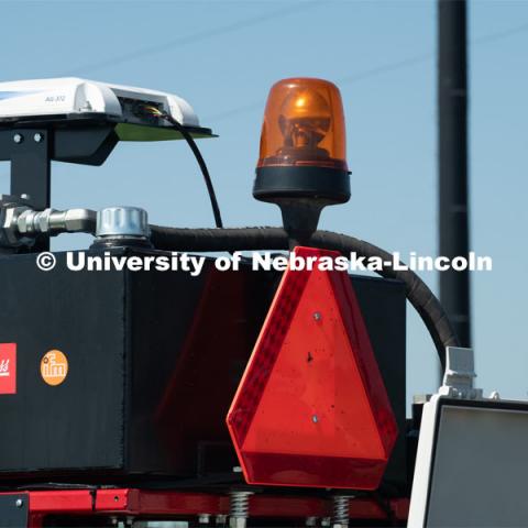 Santosh Pitla, associate professor of advanced machinery systems in the Department of Biological Systems Engineering at the University of Nebraska–Lincoln, is currently developing an autonomous tractor using ground robotics. Pitla and his team are testing their driverless tractor at the Agricultural Research and Development Center (ARDC, MEAD). The autonomous tractors are named Flexible Structured Robotic Vehicle (FlexRo), the tractor is currently used for plant phenotyping, which is measuring the physical characteristics of the plant. According to Pitla, cameras are added to the machine to collect images that characterize plant conditions. Photo for the 2019 publication of the Strategic Discussions for Nebraska magazine. July 17, 2019, Photo by Gregory Nathan / University Communication. 

