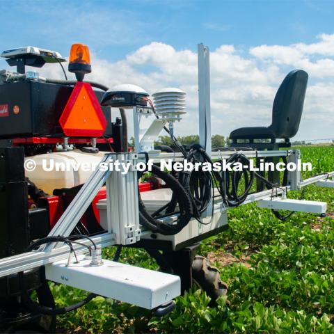 Santosh Pitla, associate professor of advanced machinery systems in the Department of Biological Systems Engineering at the University of Nebraska–Lincoln, is currently developing an autonomous tractor using ground robotics. Pitla and his team are testing their driverless tractor at the Agricultural Research and Development Center (ARDC, MEAD). The autonomous tractors are named Flexible Structured Robotic Vehicle (FlexRo), the tractor is currently used for plant phenotyping, which is measuring the physical characteristics of the plant. According to Pitla, cameras are added to the machine to collect images that characterize plant conditions. Photo for the 2019 publication of the Strategic Discussions for Nebraska magazine. July 17, 2019, Photo by Gregory Nathan / University Communication. 

