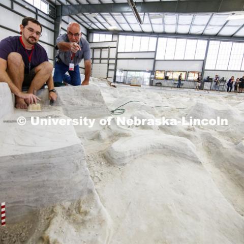 Raymond Dierdorf, an intern at the park, and Rick Otto, Superintendent of Ashfall Fossil Beds State Historical Park, discuss the project as Dierdorf removes layers of ash over a rhino skull. Ashfall Fossil Beds State Historical Park in north central Nebraska. August 2, 2019. Photo by Craig Chandler / University Communication.