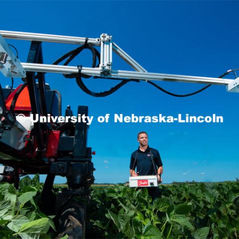 Santosh Pitla, associate professor of advanced machinery systems in the Department of Biological Systems Engineering at the University of Nebraska–Lincoln, is currently developing an autonomous tractor using ground robotics. Pitla and his team are testing their driverless tractor at the Agricultural Research and Development Center (ARDC, MEAD). The autonomous tractors are named Flexible Structured Robotic Vehicle (FlexRo), the tractor is currently used for plant phenotyping, which is measuring the physical characteristics of the plant. According to Pitla, cameras are added to the machine to collect images that characterize plant conditions. Photo for the 2019 publication of the Strategic Discussions for Nebraska magazine. July 17, 2019, Photo by Gregory Nathan / University Communication. 

