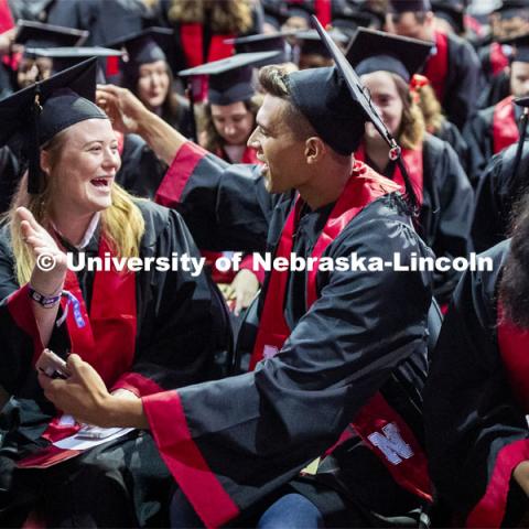 Harper Anderson and Jace Anderson hug during the ceremony when Regent Tim Claire asked all the grads to interact with the people around them. 2019 Summer Commencement at Pinnacle Bank Arena. August 17, 2019. Photo by Craig Chandler / University Communication.