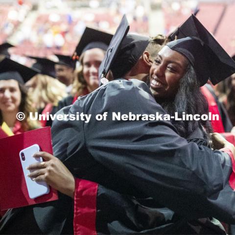 Jace Anderson and Bezawit Bekele hug during the ceremony when Regent Tim Claire asked all the grads to interact with the people around them. 2019 Summer Commencement at Pinnacle Bank Arena. August 17, 2019. Photo by Craig Chandler / University Communication.