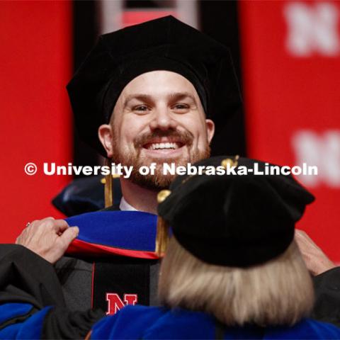 Zachary Myers is hooded by his advisor Sue Swearer. 2019 Summer Commencement at Pinnacle Bank Arena. August 17, 2019. Photo by Craig Chandler / University Communication.