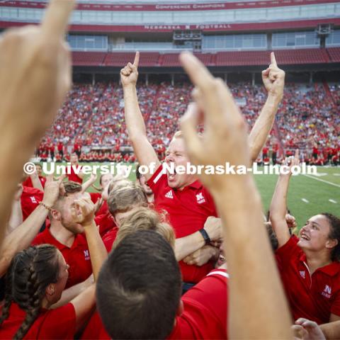 Sam Brown, an alto saxophone player from Omaha, celebrates with fellow band members after winning the annual drill down marching competition. Cornhusker Marching Band Exhibition Performance. August 23, 2019. Photo by Craig Chandler / University Communication.