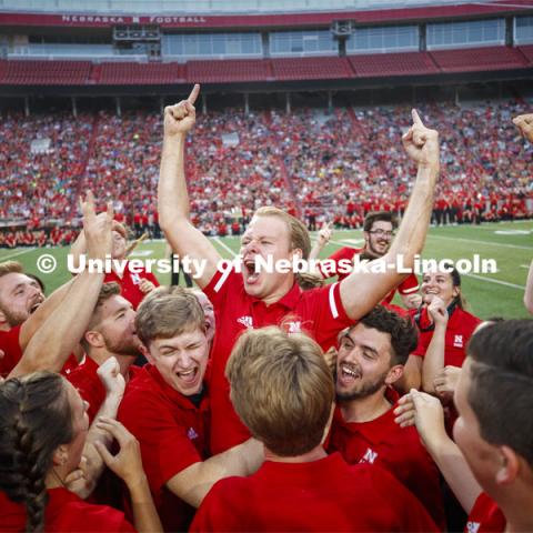 Sam Brown, an alto saxophone player from Omaha, celebrates with fellow band members after winning the annual drill down marching competition. Cornhusker Marching Band Exhibition Performance. August 23, 2019. Photo by Craig Chandler / University Communication.