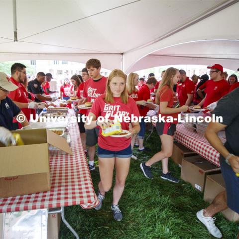 Students work their way through multiple food lines at the picnic. Big Red Welcome, Chancellor's BBQ for incoming freshman and new students on the greenspace by the Memorial Union. August 23, 2019. Photo by Craig Chandler / University Communication.