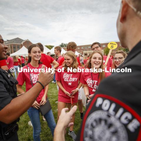 UNL Police Officers Terrell Long Jr. and Craig Tepley engage with students in an in-depth conversation on why the game is called corn hole in Nebraska. Big Red Welcome, Chancellor's BBQ for incoming freshman and new students on the greenspace by the Memorial Union. August 23, 2019. Photo by Craig Chandler / University Communication.