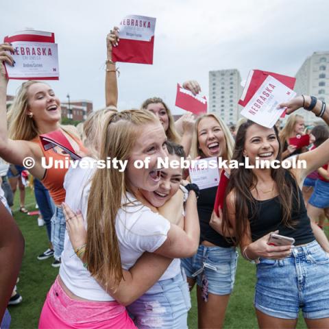 New sorority members celebrate their bids as they open their invitations on the intramural fields. Sorority Bid Day. August 24, 2019. Photo by Craig Chandler / University Communication.