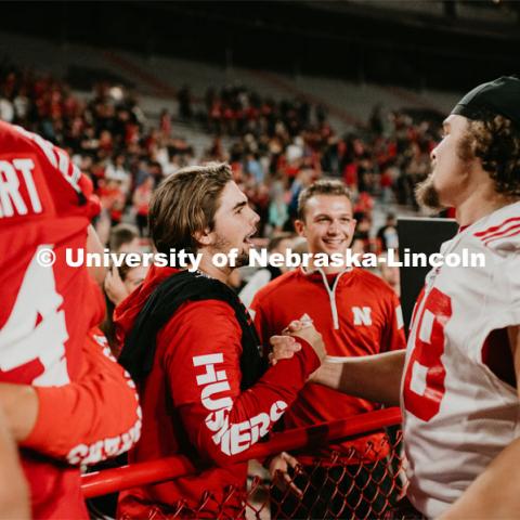 Football players meeting fans and students. Student making a catch and the team going wild, she was the only one to catch the ball. Students got to check out the 2019 Husker Football Team at the Big Red Welcome Boneyard Bash. The first 2500 students got a free slice of Valentino’s pizza, water, and a 2019 Official Boneyard t-shirt. August 24, 2019. Photo by Justin Mohling / University Communication.