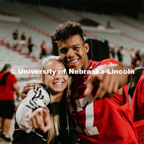 Football players meeting fans and students. Student making a catch and the team going wild, she was the only one to catch the ball. Students got to check out the 2019 Husker Football Team at the Big Red Welcome Boneyard Bash. The first 2500 students got a free slice of Valentino’s pizza, water, and a 2019 Official Boneyard t-shirt. August 24, 2019. Photo by Justin Mohling / University Communication.