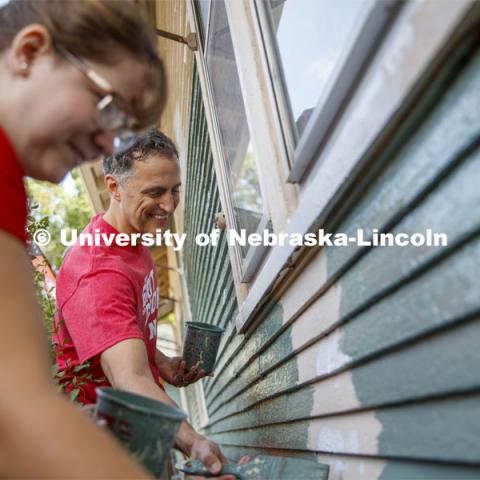 Richard Moberly, Interim Executive Vice Chancellor and Chief Academic Officer paints alongside incoming law students at a home at 30th and Vine. First year law students, faculty and staff paint two Lincoln houses. The painting is a yearly tradition for the incoming students. August 24, 2019. Photo by Craig Chandler / University Communication.