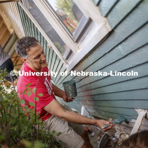 Richard Moberly, Interim Executive Vice Chancellor and Chief Academic Officer paints alongside incoming law students at a home at 30th and Vine. First year law students, faculty and staff paint two Lincoln houses. The painting is a yearly tradition for the incoming students. August 24, 2019. Photo by Craig Chandler / University Communication.