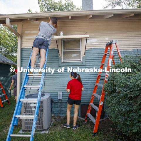 First year law students, faculty and staff paint two Lincoln houses. The painting is a yearly tradition for the incoming students. August 24, 2019. Photo by Craig Chandler / University Communication.