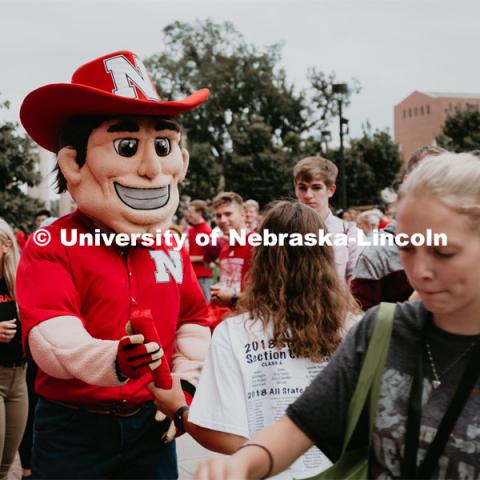 Herbie handing out free stuff. Students had the opportunity to engage with more than 350 booths hosted by local business, student organizations and clubs, UNL departments and more at the Big Red Welcome Street Festival. There were free food, prizes, and giveaways. August 24, 2019. Photo by Justin Mohling / University Communication.