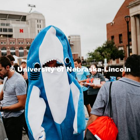 Student dressed as a shark. Students had the opportunity to engage with more than 350 booths hosted by local business, student organizations and clubs, UNL departments and more at the Big Red Welcome Street Festival. There were free food, prizes, and giveaways. August 24, 2019. Photo by Justin Mohling / University Communication.