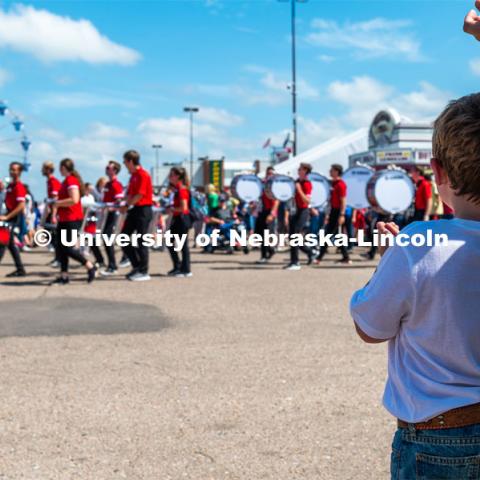 Kids watch the Cornhusker Marching Band march by. The University of Nebraska represents and celebrates their 150th year anniversary at the Nebraska State Fair in Grand Island, Nebraska. August 1, 2019. Photo by Justin Mohling for University Communication.