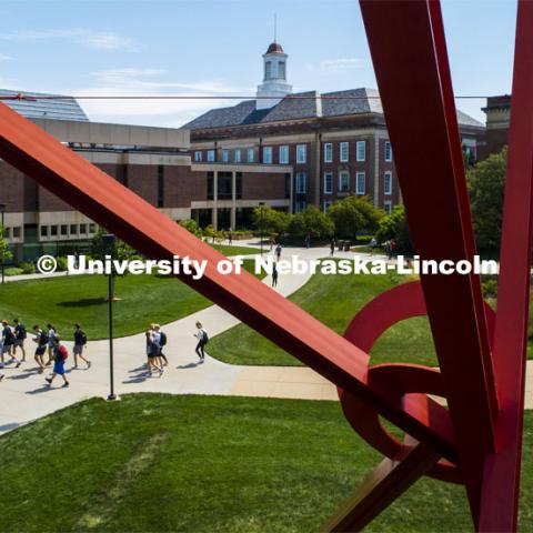 Students cross city campus under the gaze of Old Glory. September 4, 2019. Photo by Craig Chandler / University Communication.