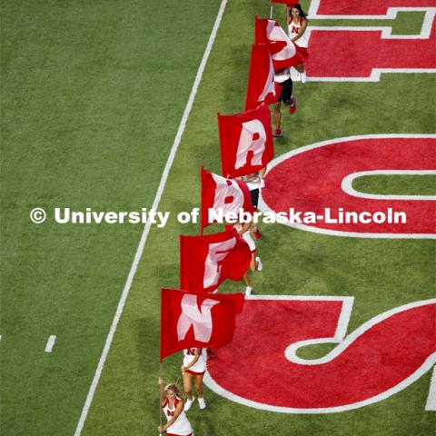 The Husker Spirit Squad spell out NEBRASKA with flags as they run out onto the field at the Nebraska vs. Northern Illinois football game. September 14, 2019. Photo by Craig Chandler / University Communication.