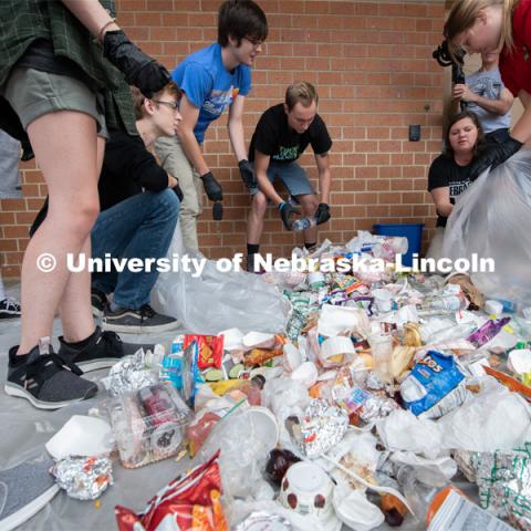 Students from the Environmental Studies Orientation class, including Luke Stursma, (lower left) William Raney, Leo Schwantz, instructor Christine Haney Douglass and Anna Janda sort refuse from lunch at Lincoln Southwest High School. September 25, 2019. Photo by Greg Nathan / University Communication.