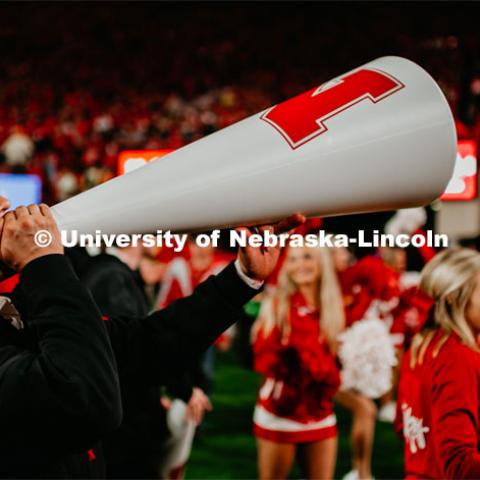 Male cheerleader using megaphone to pump up crowd at the Nebraska vs. Ohio State University football game. September 28, 2019. Photo by Justin Mohling / University Communication.