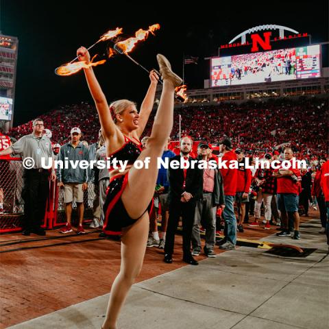 Twirler Carrigan Hurst twirling with batons lit on fire. Nebraska vs. Ohio State University football game. September 28, 2019. Photo by Justin Mohling / University Communication.