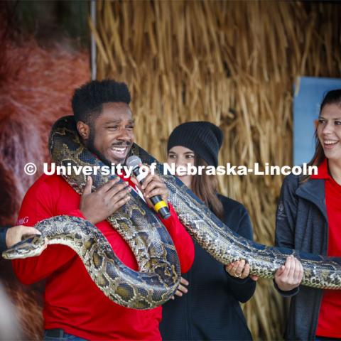 Emcee D-Wayne Taylor makes friends with a boa constrictor at the Mutual of Omaha animal exhibit. Cornstock celebration and Homecoming Parade. October 4, 2019. Photo by Craig Chandler / University Communication.