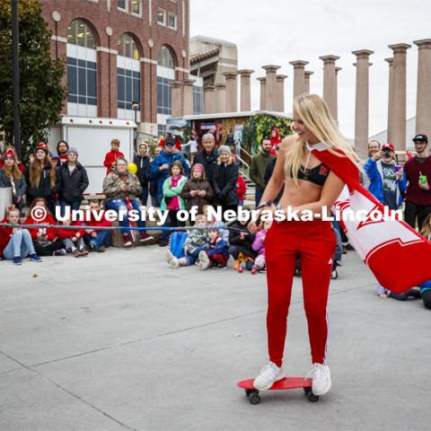 Allison Hinrichs, junior from Lincoln, is pulled by the truck and boat holding the rest of the water ski club. Cornstock celebration and Homecoming Parade. October 4, 2019. Photo by Craig Chandler / University Communication.